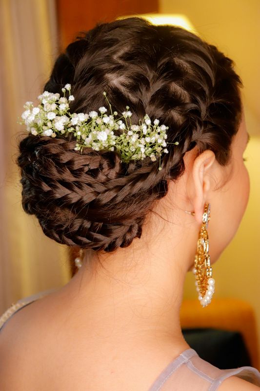 Braided bridal updo with baby's breath flowers