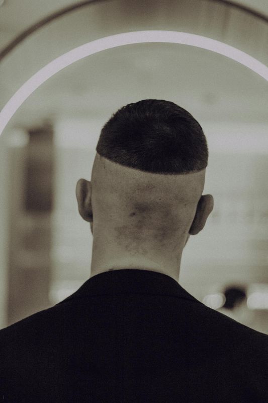 Clean buzz cut with a sharp line-up, back view